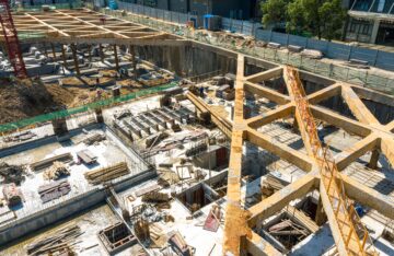 Aerial shot of the construction site in the summer morning.