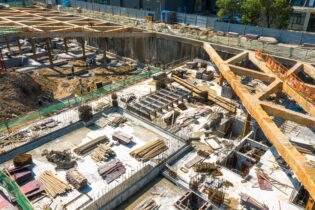 An aerial view of a construction site in the center of a modern city