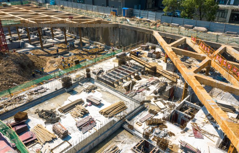 An aerial view of a construction site in the center of a modern city